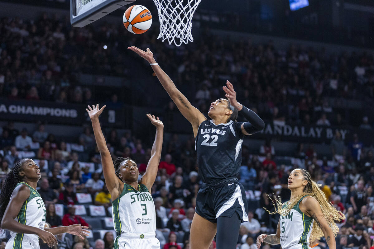 Aces center A'ja Wilson (22) lays the ball in over Seattle Storm forward Nneka Ogwumike (3) dur ...