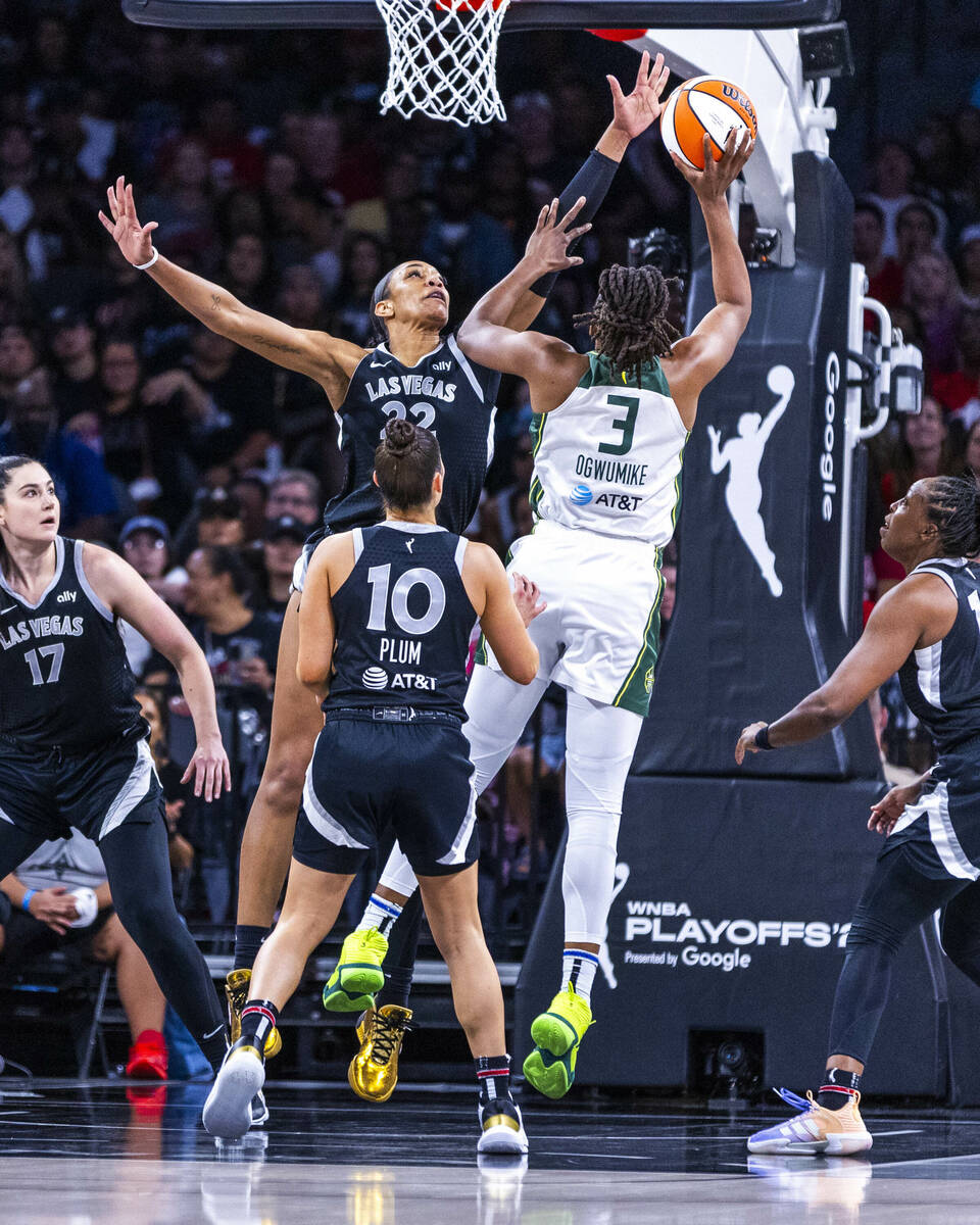 Aces center A'ja Wilson (22) sets up to block a shot attempt by Seattle Storm forward Nneka Ogw ...