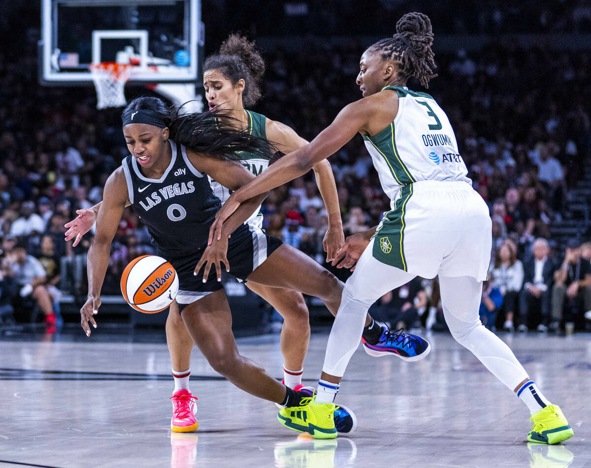 Aces guard Jackie Young (0) is fouled by Seattle Storm forward Nneka Ogwumike (3) with guard Sk ...