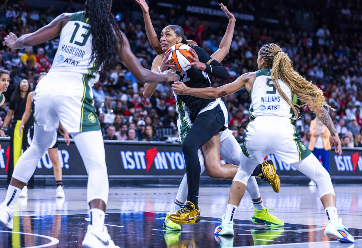 Aces center A'ja Wilson (22) drives to the net against Seattle Storm forward Gabby Williams (5) ...