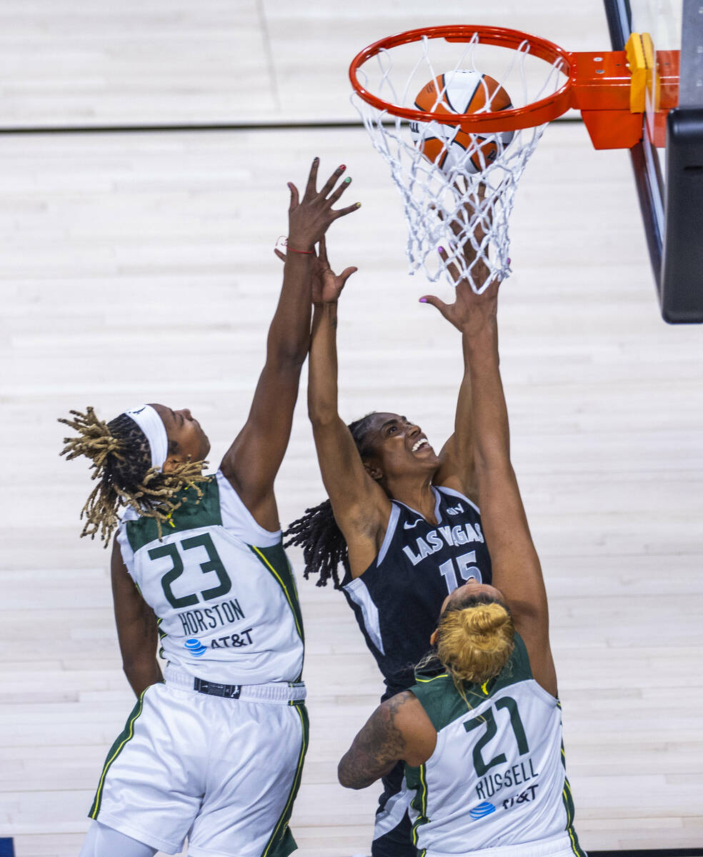 Aces guard Tiffany Hayes battles up for a basket past Seattle Storm guard Jordan Horston (23) a ...