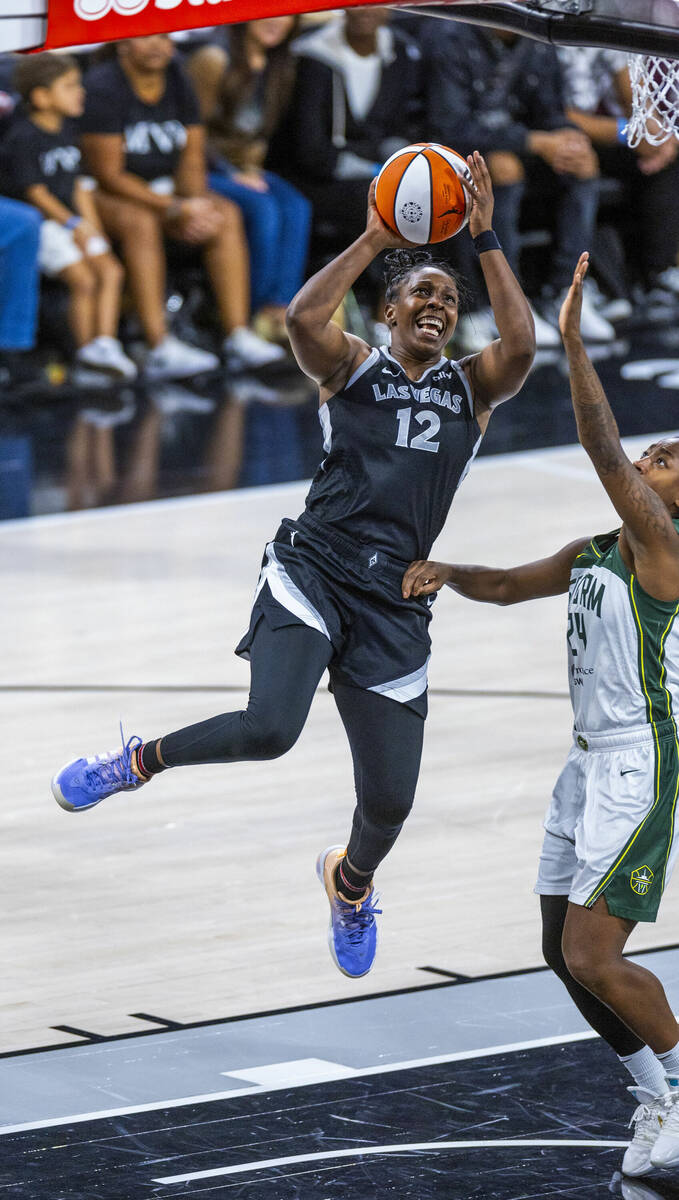 Aces guard Chelsea Gray (12) elevates to score late against Seattle Storm guard Jewell Loyd (24 ...