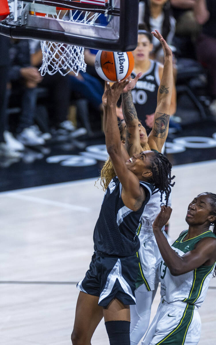 Aces guard Tiffany Hayes (15) gets a critical late basket over Seattle Storm forward Gabby Will ...