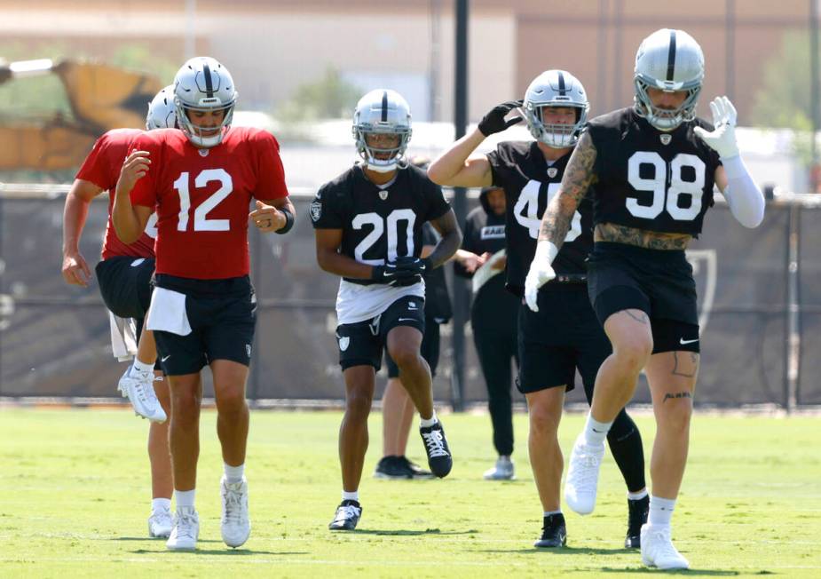 Raiders quarterback Aidan O'Connell (12), safety Isaiah Pola-Mao (20), linebacker Tommy Eichenb ...