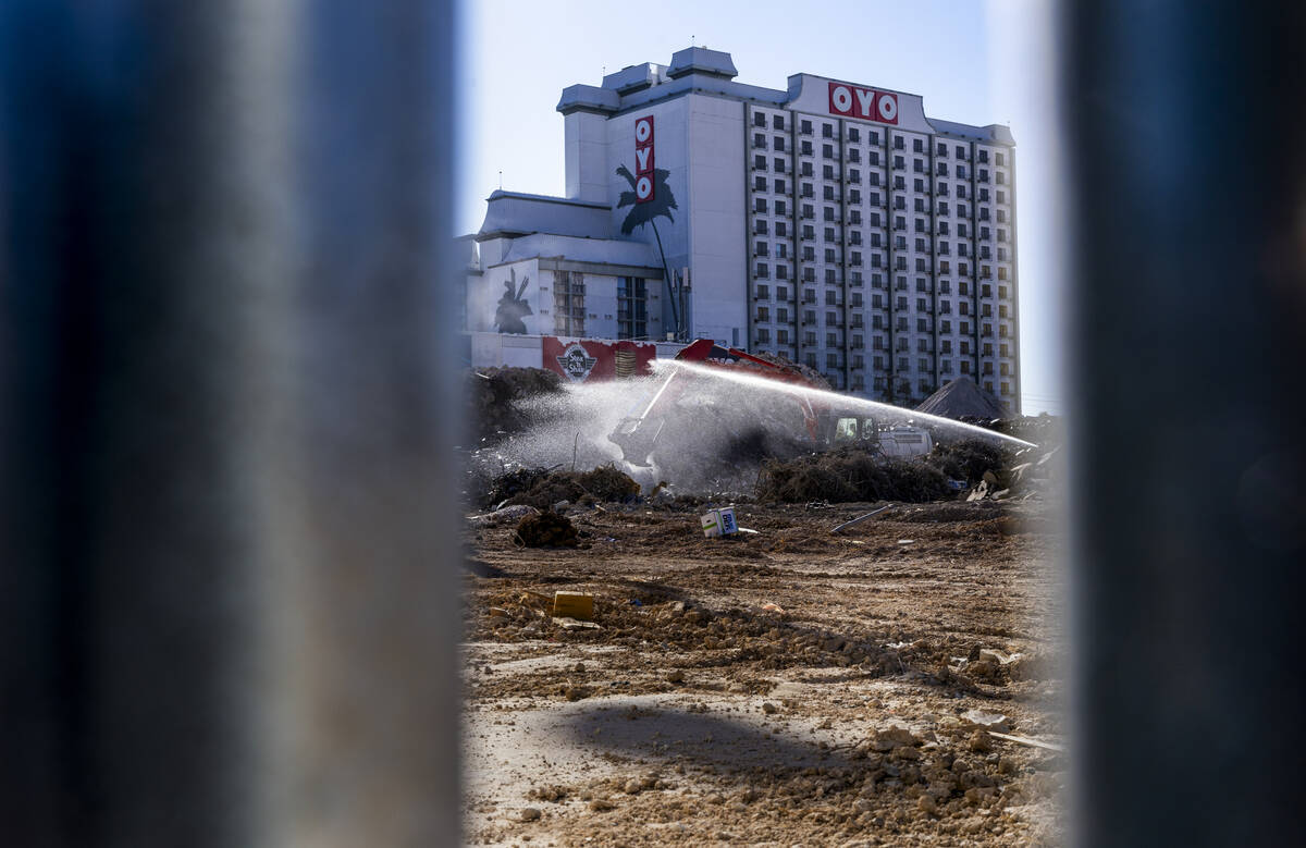 Water is sprayed to keep dust down on piles of debris as they continue growing while preparatio ...