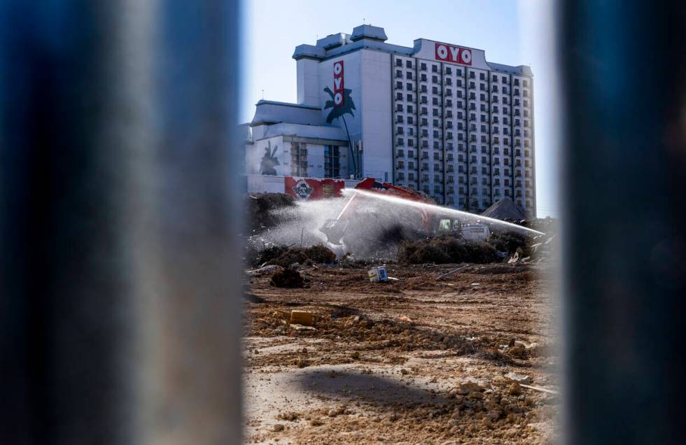 Water is sprayed to keep dust down on piles of debris as they continue growing while preparatio ...