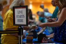 Voters fill out documents before casting their ballot during the Nevada Primary Day Elections o ...