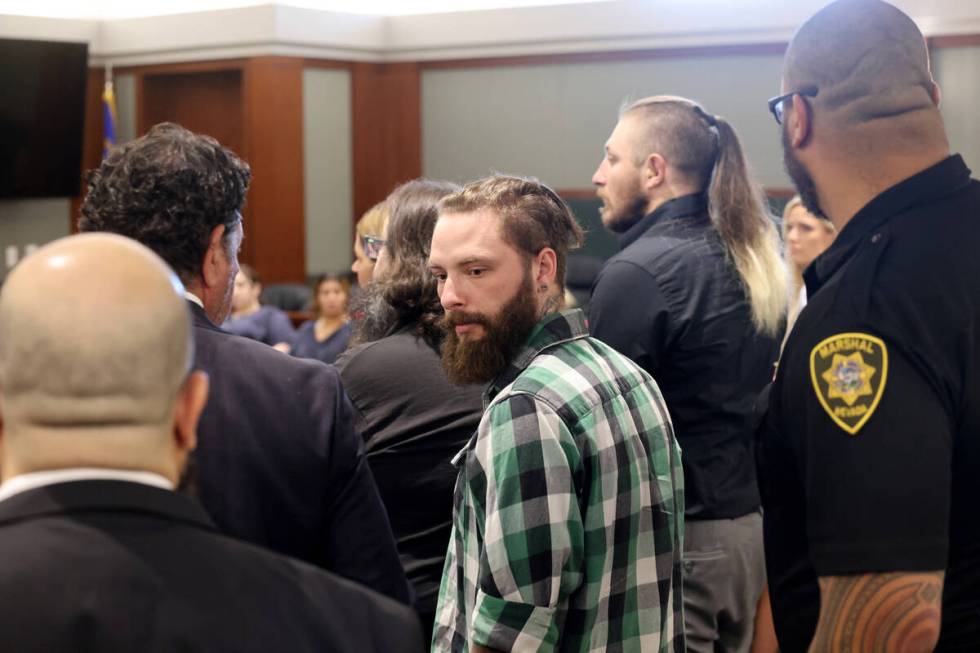 Casey Dunne, center, one of 11 indicted alleged motorcycle gang members, appears in court at th ...