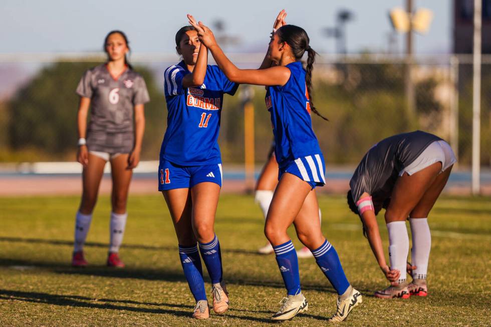 Bishop Gorman midfielder Devyn Giraldo (11) and teammate Alana Moore (9) celebrate a ...