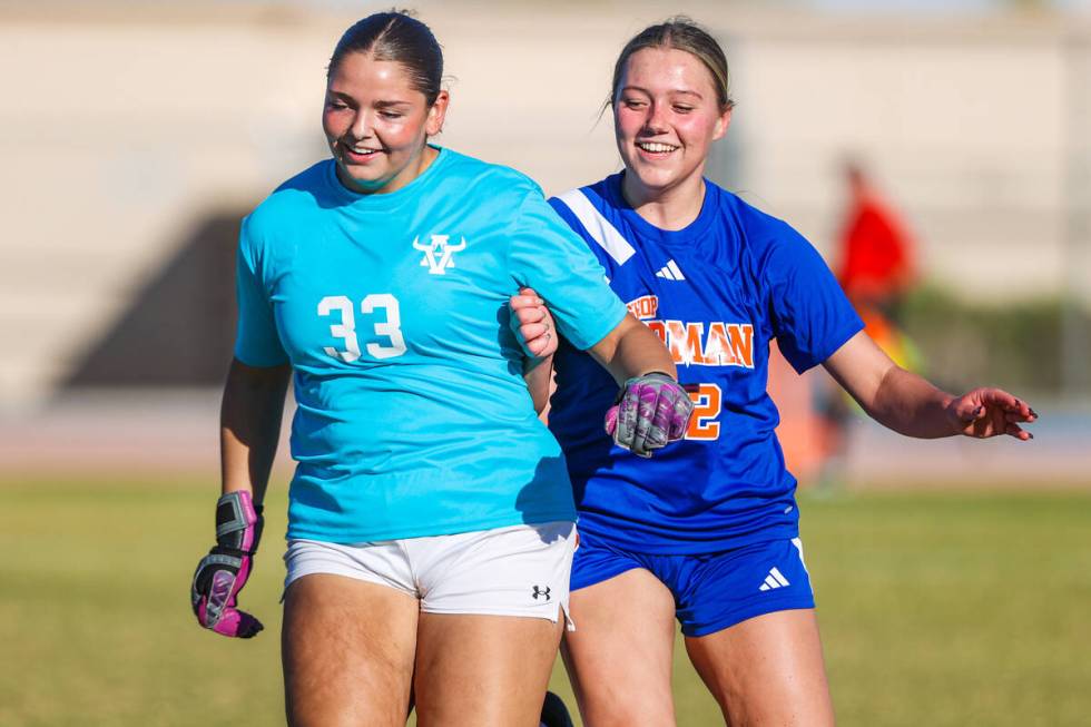 Bishop Gorman forward Grace Allen (22) and Arbor View goalkeeper Emily Marks (33) laugh as they ...