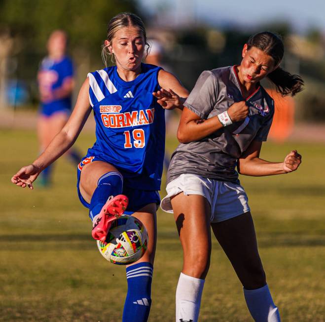 Arbor View’s Aspen Romeo (1) braces for impact as Bishop Gorman forward Riley Rohr (19) ...