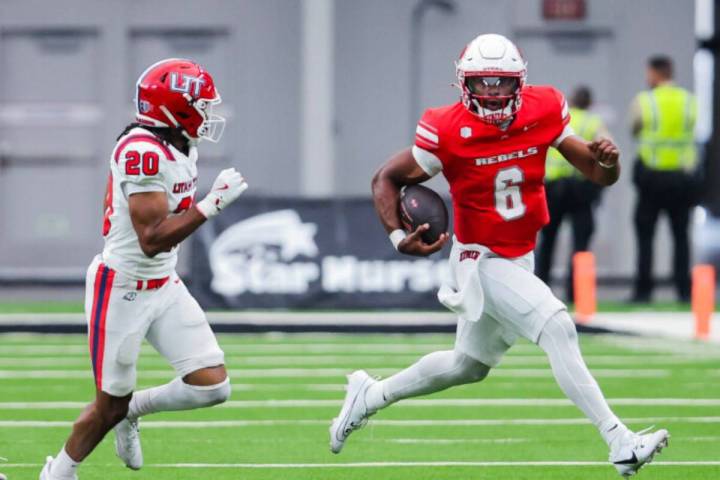 UNLV quarterback Hajj-Malik Williams (6) scrambles with the ball during an NCAA football game b ...