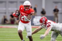 UNLV running back Michael Allen (26) outruns Utah Tech linebacker Spencer Rich (45) during the ...