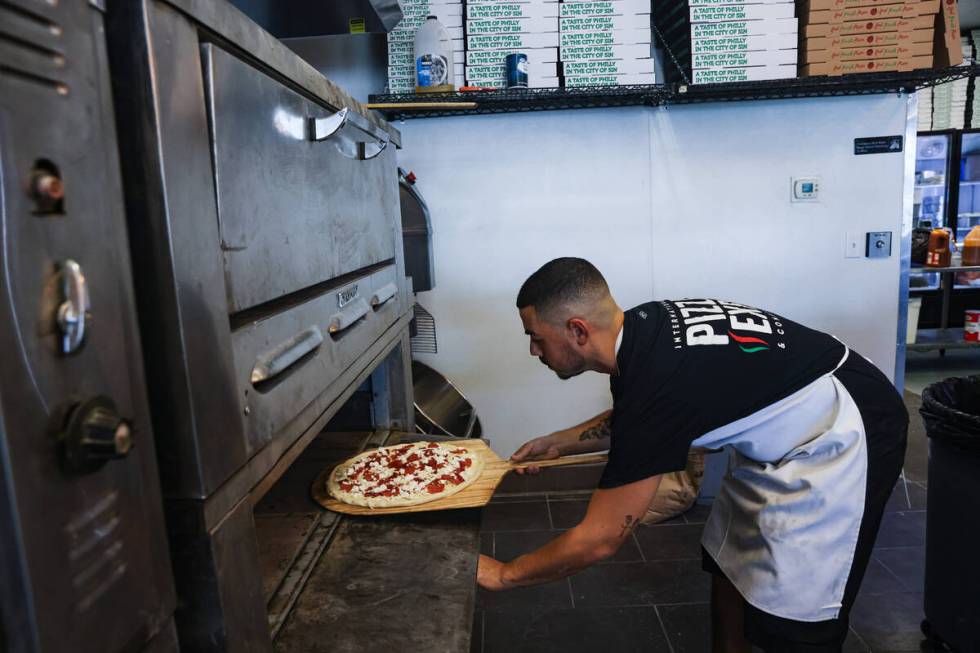 Owner Joey Scolaro prepares the Upside Down Pizza at Lucino’s pizza in Las Vegas, Thursd ...