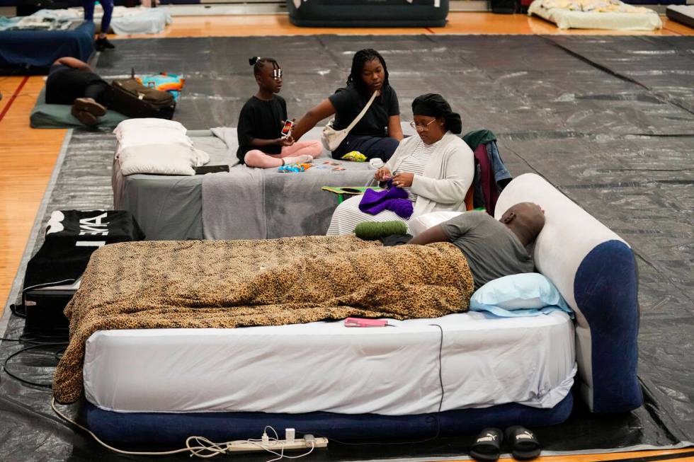 Sharonda and Victor Davis, of Tallahassee, sit with their children Victoria background left, an ...