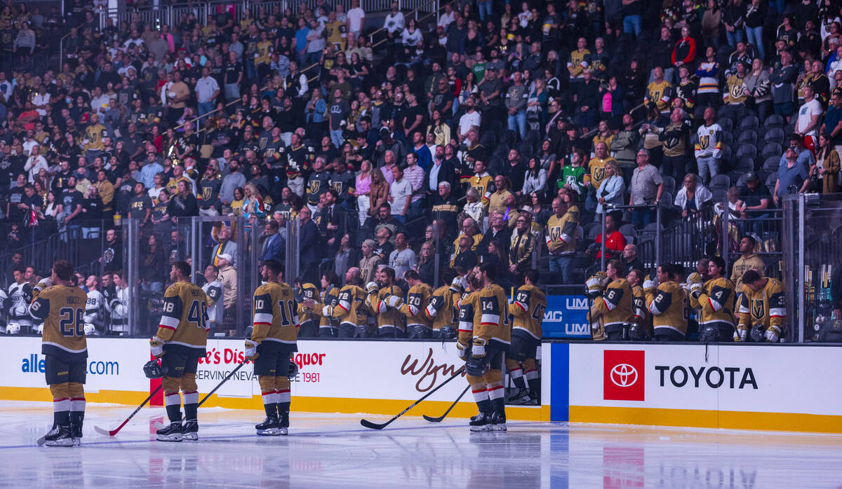 Golden Knights and Los Angeles Kings players stand for a tribute before the first period of the ...