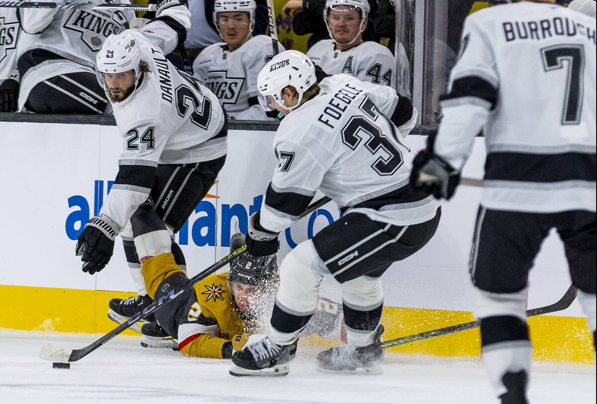 Golden Knights defenseman Zach Whitecloud (2) looks to the puck from the ice as Los Angeles Kin ...