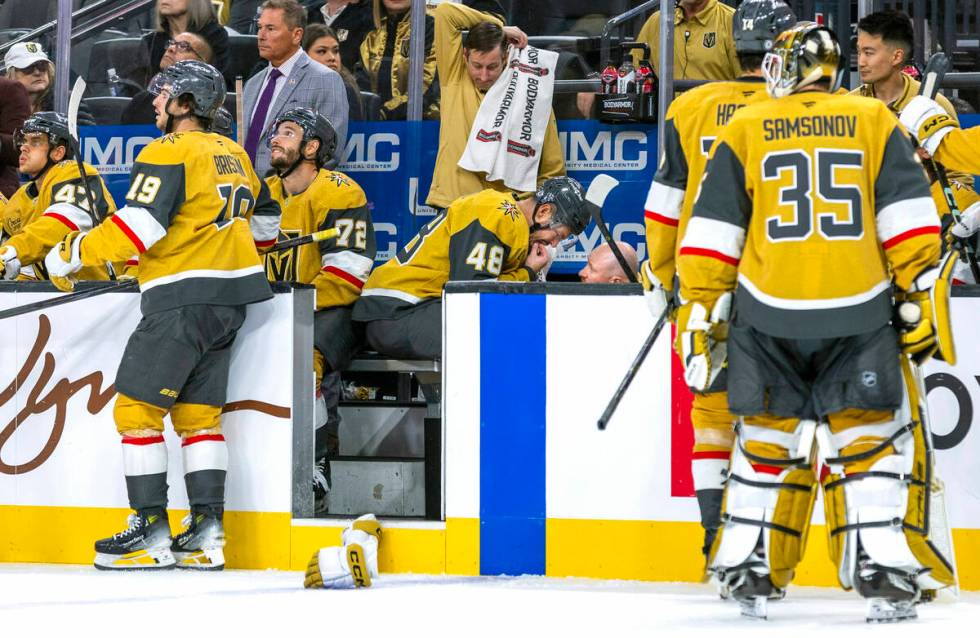 Golden Knights center Tomas Hertl (48) has a tooth examined by head athletic trainer Kyle Moore ...