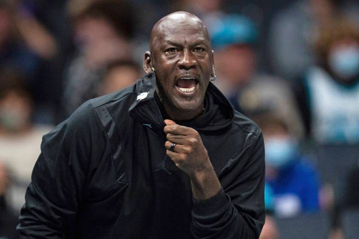 FILE - Michael Jordan looks on during the first half of an NBA basketball game between the Char ...