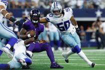 Baltimore Ravens quarterback Lamar Jackson (8) carries the ball as Caelen Carson (21) and Eric ...