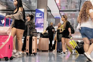 Arriving passengers head to baggage claim area at Terminal 1 of Harry Reid International Airpor ...