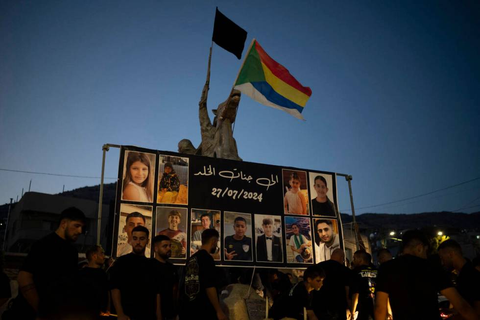 Photos of the children and teens killed in a rocket strike at a soccer field, are displayed at ...