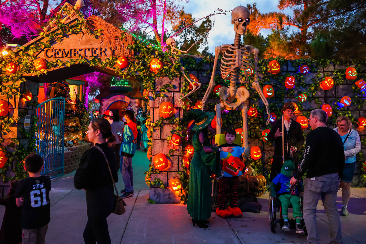 Attendees walk past Halloween decor during HallOVeen at the Magical Forest at Opportunity Villa ...