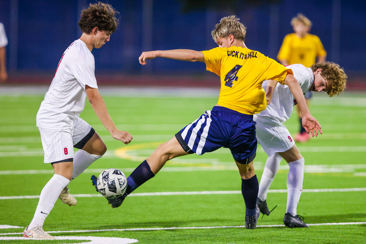 Shadow Ridge defender Carson Gregory (4) kicks the ball away from Liberty midfielder Rowan Durf ...