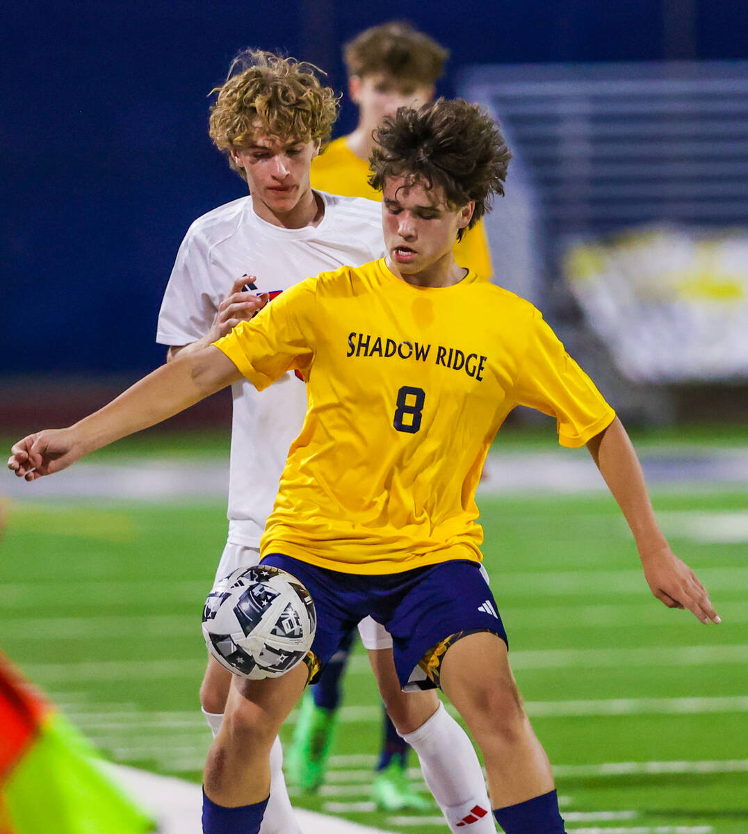 Shadow Ridge midfielder Conor Taylor (8) chases the ball out of bounds during a soccer match be ...