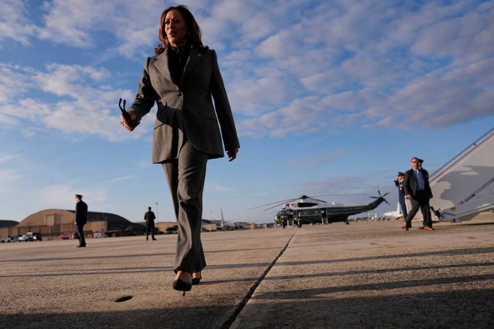 Democratic presidential nominee Vice President Kamala Harris walks over to speak to members of ...