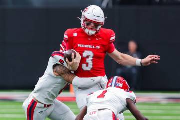 UNLV quarterback Matthew Sluka (3) is surrounded by Utah Tech defense during an NCAA football g ...