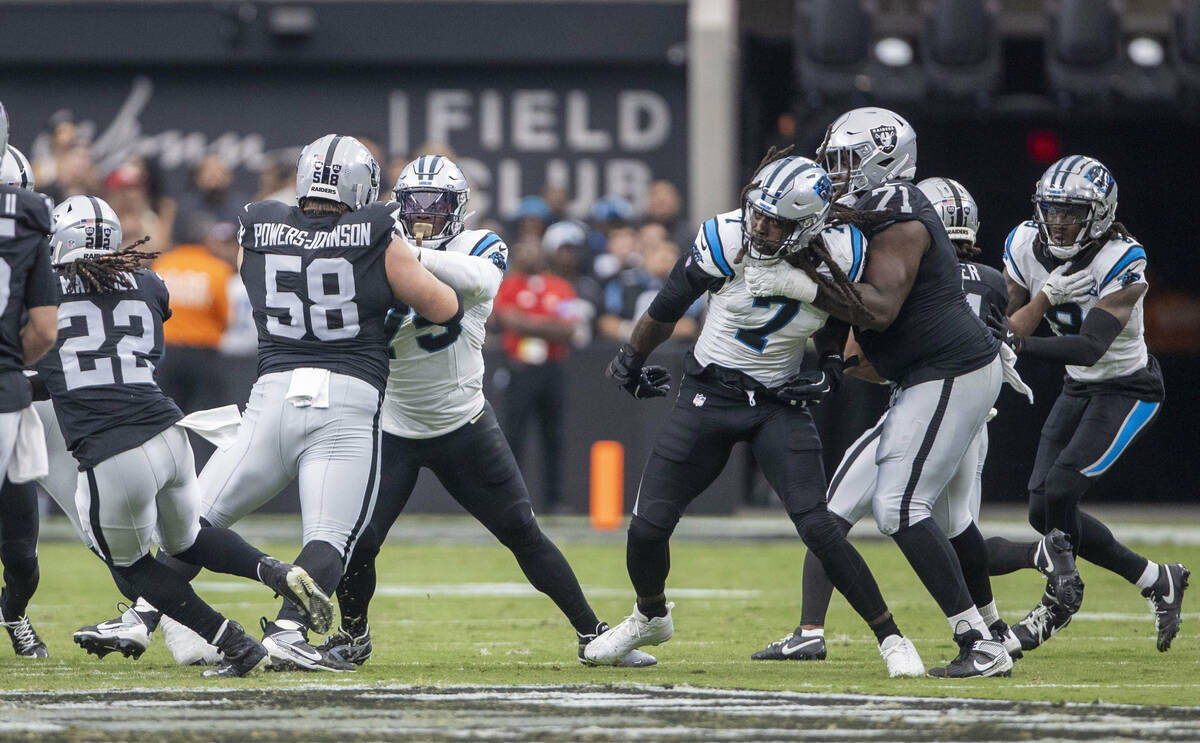 Raiders guard Jackson Powers-Johnson (58) and Raiders offensive tackle DJ Glaze (71) block agai ...