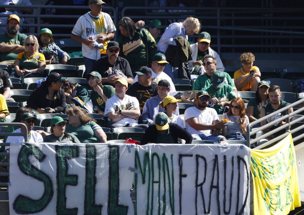 Oakland Athletics fans display signs as they watch the final home game against the Texas Ranger ...