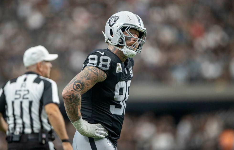 Raiders defensive end Maxx Crosby (98) looks to replay after a big play from the Carolina Panth ...