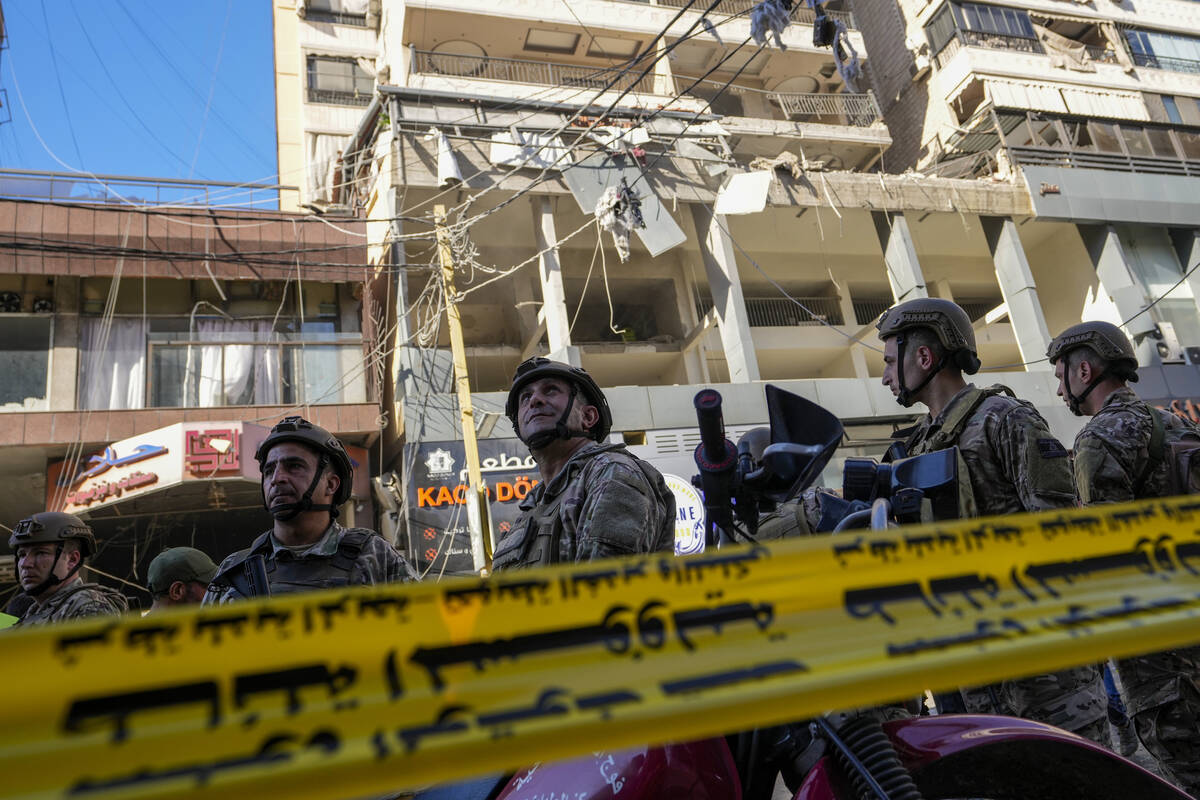 Lebanese soldiers cordon off the area at the site of an Israeli airstrike in Beirut's southern ...