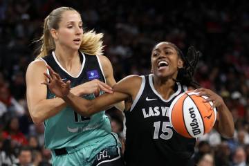 Las Vegas Aces guard Tiffany Hayes (15) drives toward the hoop against New York Liberty guard I ...