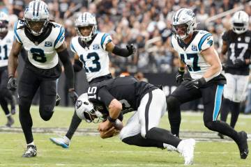 Raiders quarterback Gardner Minshew (15) stumbles as he runs with ball against Carolina Panther ...