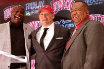 New UNLV football coach Barry Odom is introduced with Athletic Director Erick Harper, left, and ...