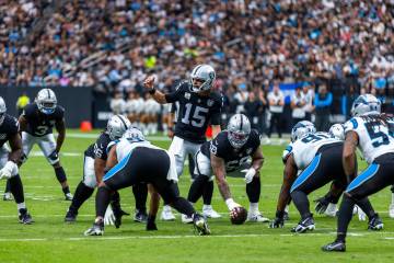 Raiders quarterback Gardner Minshew (15) makes an adjustment during the first half of their NFL ...