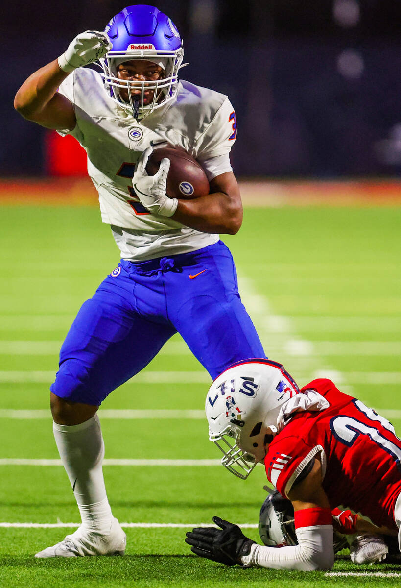 Bishop Gorman running back Terrance Grant (3) tries to move his leg as Liberty defensive back M ...