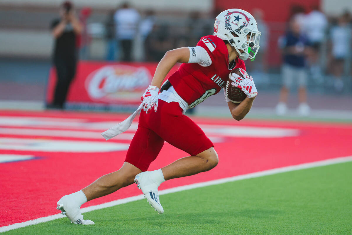 Liberty wide receiver Kellen Iwamuro (8) runs the ball during a kickoff at a high school footba ...