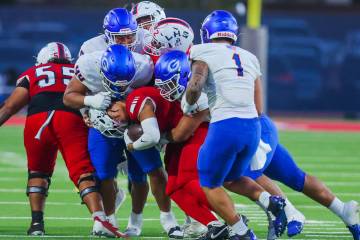 Bishop Gorman defensive lineman Sione Motuapuaka (44) pulls Liberty running back Ezra Sanelivi& ...