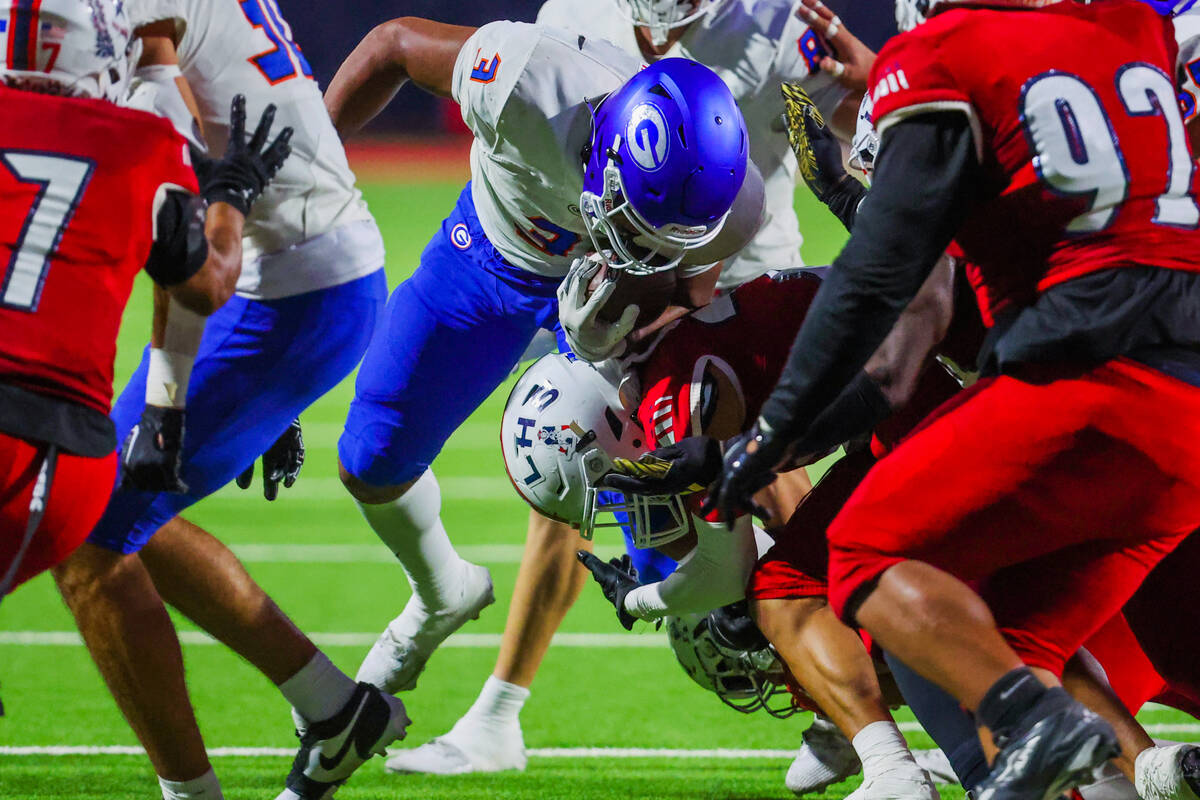 Bishop Gorman running back Terrance Grant (3) forces his way through a gaggle of players during ...