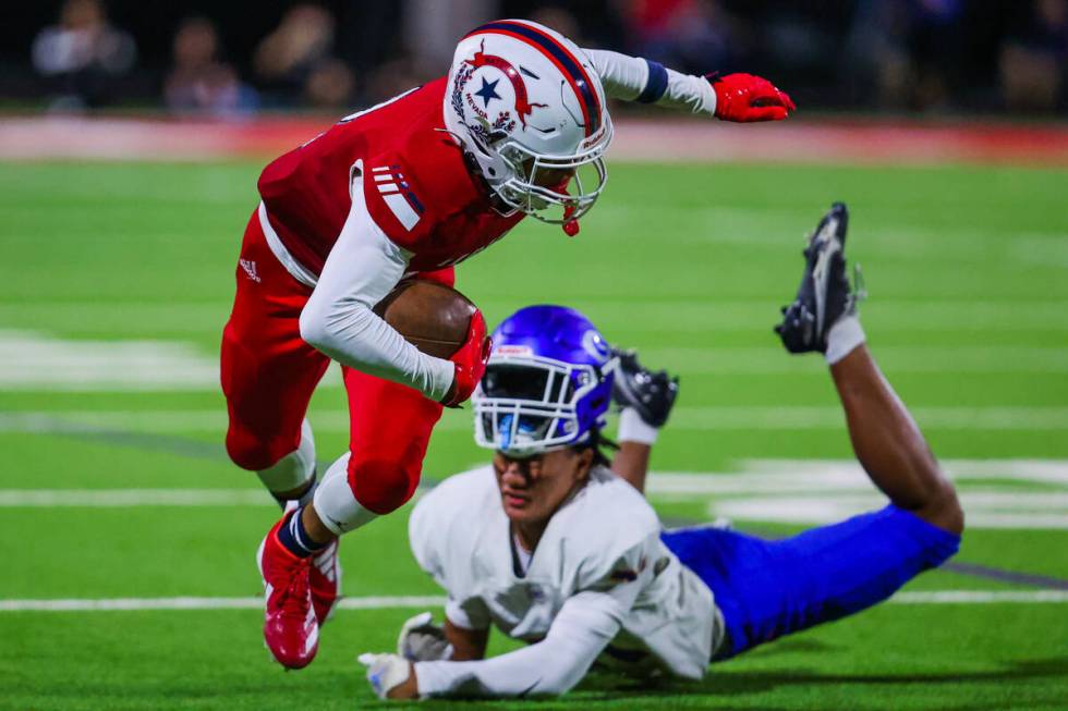 Liberty wide receiver Treven Edington (2) runs the ball down the field during a high school foo ...