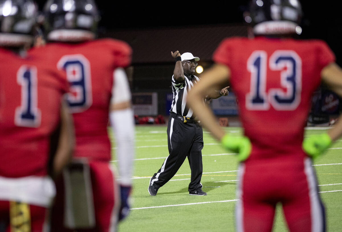 The head referee signals that Arbor View recovered the ball after Coronado fumbled a punt durin ...