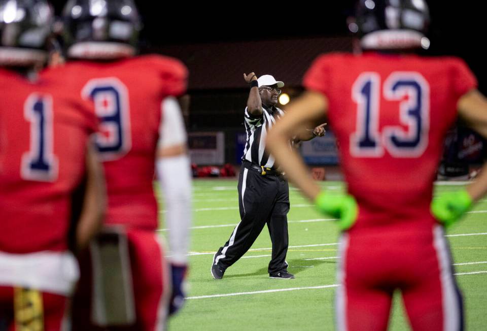 The head referee signals that Arbor View recovered the ball after Coronado fumbled a punt durin ...