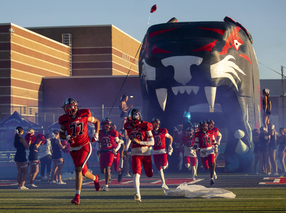 Coronado players run out of the tunnel before the high school football game against Arbor View ...