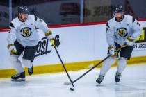 Golden Knights center Jack Eichel (9) advances the puck beside defenseman Alex Pietrangelo (7) ...