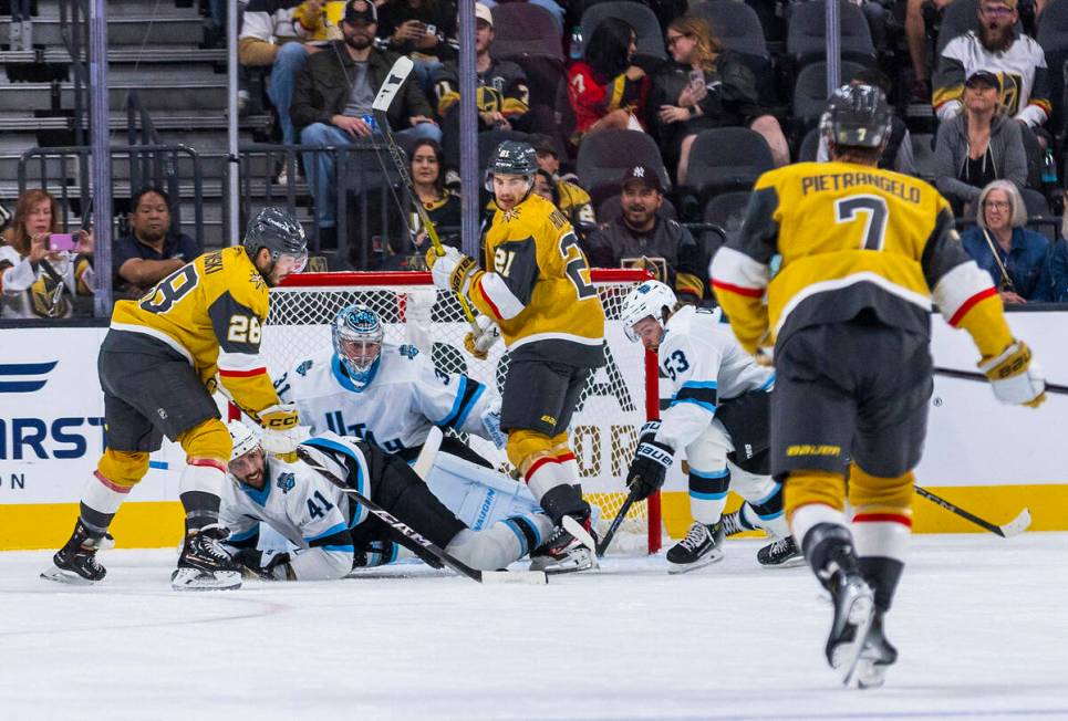 Utah Hockey Club defenseman Ian Cole (28) takes a shot at the net and Utah Hockey Club goaltend ...