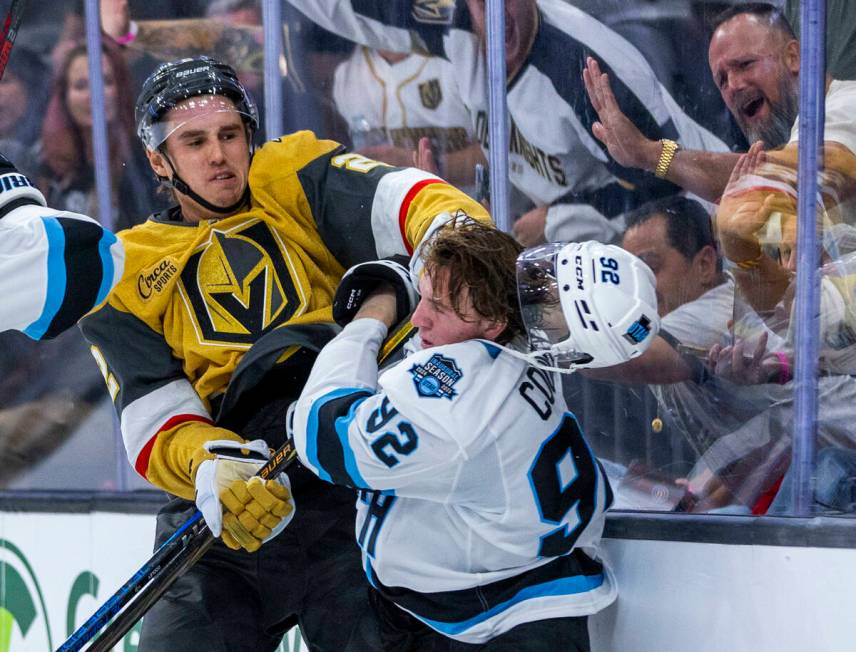 Golden Knights defenseman Zach Whitecloud (2) punches Utah Hockey Club forward Logan Cooley (92 ...